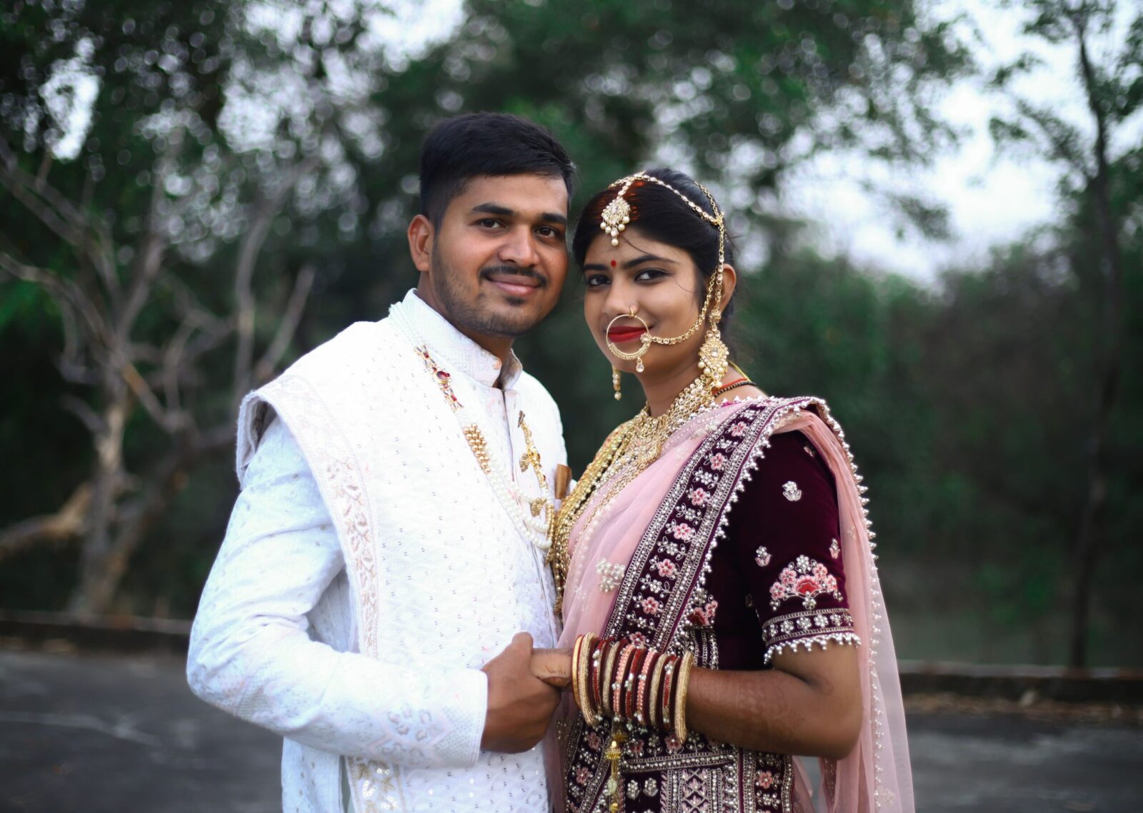 South Asian couple in traditional attire posing during their wedding ceremony in Jharkhand, India.